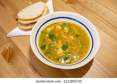 Soup Lunch With Bread. A Bowl Of Chicken And Veg Soup With Crusty Bread On Napkin. Warm Winter Food On Table. 