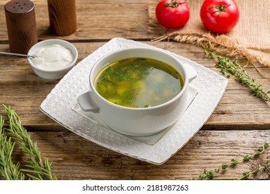 Soup With Sorrel And Sour Cream On Old Wooden Table