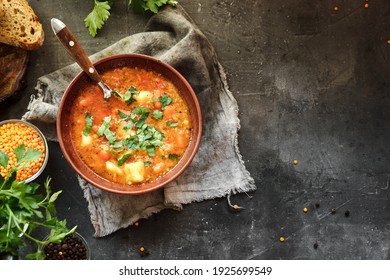 Soup with vegetables and red lentils. Vegan soup with beans and tomatoes.