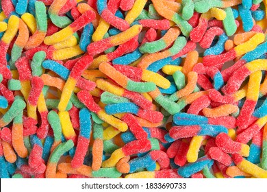 Sour Candy Gummy Worms Close Up Background. Covered In Granulated Sugar. Flat Lay Top View From Above.