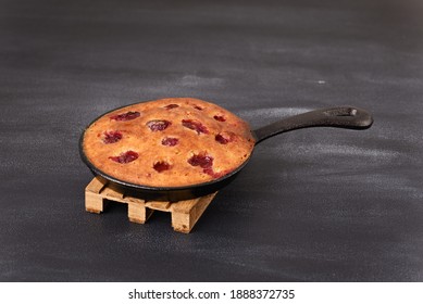 Sour Cherry Cake In A Pan, On A Wooden Trivet.