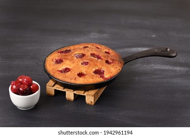 Sour Cherry Cake In A Pan On A Wooden Trivet.