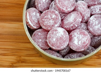 Sour Cherry Drops. Hard Candy With A Sour Flavor With Icing Sugar In A Tin Can. Close Up.