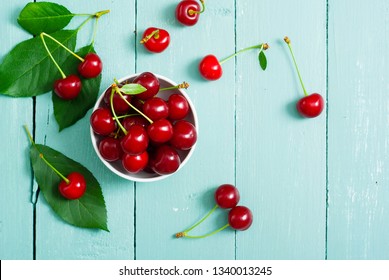 sour cherry fruits at bowl on old blue wood table