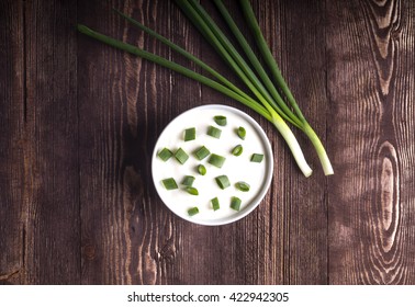 Sour Cream And Onion On A Wooden Dark Background Top View.