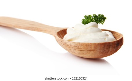 Sour Cream In Spoon Isolated On White