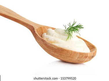 Sour Cream In Spoon Isolated On White