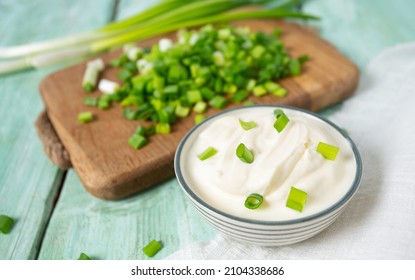 sour cream with spring onion - Shutterstock ID 2104338686