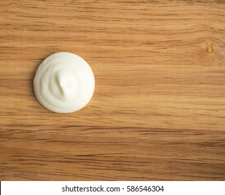 Sour Cream Swirl Or White Yogurt On A Wooden Background Top View