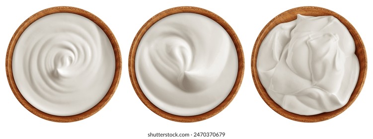 Sour Cream in wooden bowl, Mayonnaise, Yogurt, isolated on white background, clipping path, full depth of field