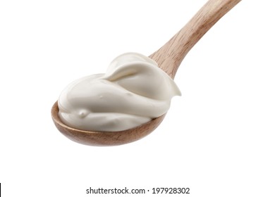 Sour Cream In Wooden Spoon Isolated