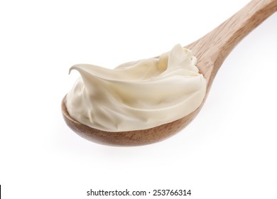 Sour Cream In Wooden Spoon Isolated