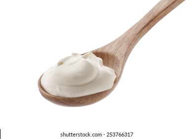 Sour Cream In Wooden Spoon Isolated