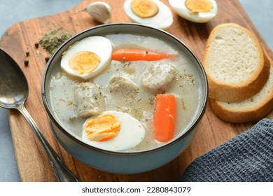 The sour soup (zurek) made of rye flour with sausage and egg. Popular Easter dish - Shutterstock ID 2280843079