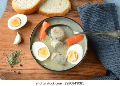 The sour soup (zurek) made of rye flour with sausage and egg. Popular Easter dish - Shutterstock ID 2280843081