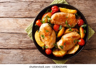 Sour Sweet Chicken Breast Baked With Peaches, Tomatoes, Onion, Parsley And Honey Garlic Sauce Close-up On A Plate On A Table. Horizontal Top View From Above
