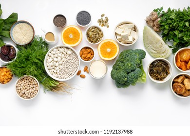 Source of calcium for vegetarians. Healthy food clean eating: fruit, vegetable, seeds, superfood, leaf vegetable on white background top view