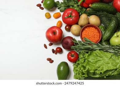 Source of protein for vegetarians. Different fresh vegetables, fruits and herbs on white marble table, space for text