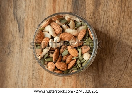 Source of trace elements, fatty acids and vegetable protein. Healthy eating. Nut and seed mix. Pumpkin seeds. Foods to reduce anxiety. Allergen foods. Lowering cholesterol. Dessert replacement. Healthy lifestyle. Healthy ready meals. Glass container. Clay bowl. Gifts of nature. Snack for beer.