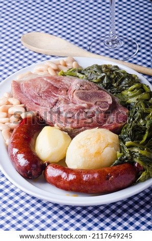 Source with a typical dish from Galicia (Spain) called lacon con grelos, accompanied by chorizo and tender beans.