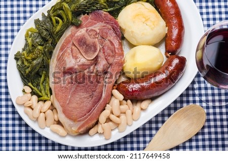 Source with a typical dish from Galicia (Spain) called lacon con grelos, accompanied by chorizo and tender beans.