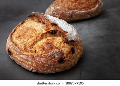Sourdough bread with mixed fruits and nuts on dark cement background. - Shutterstock ID 1889599105