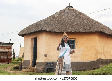 SOUTH AFRICA - AUG 13: Traditional Healer From The Xhosa Culture Standing Outside Her Hut. Round Hut Made From Sticks And Mud In The Transkei Region Of Eastern Cape (South Africa). August 13, 2016.