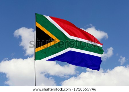 South Africa flag isolated on the blue sky with clipping path. close up waving flag of South Africa. flag symbols of South Africa.