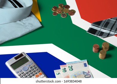 South Africa Flag On Minimal Money Concept Table. Coins And Financial Objects On Flag Surface. National Economy Theme.
