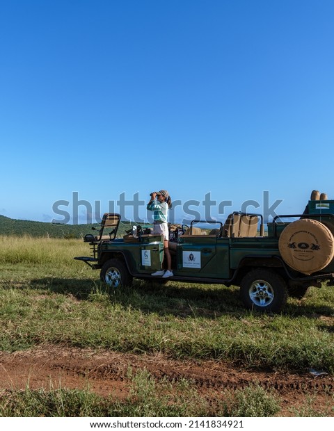 South Africa Kwazulu Natal February 20222, luxury safari\
car during a game drive, couple men and woman on safari in South\
Africa. 