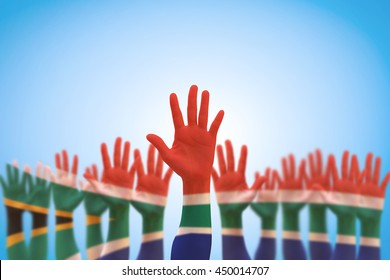 South Africa national flag pattern on leader's palm (clipping path) on blue sky background 