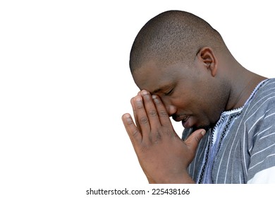 South African black young man with closed eyes and praying hands in his face. Image isolated on white studio background.