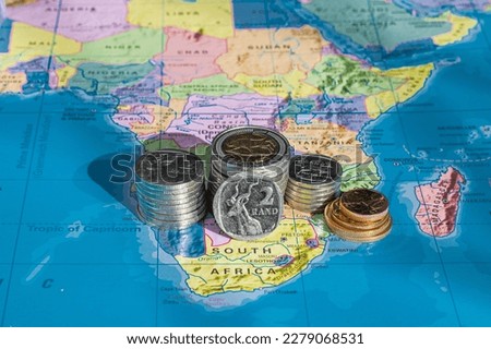 South African Coins in a Pile, Map background, showing one, two and five Rand, Close Up