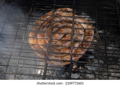 South African Lamb Sausage, Known As Boerewors, Being Grilled Over Hot Coals, As Part Of A Traditional South African Cooking Tradition Called 