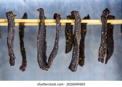 South african meat biltong dries on wooden sticks