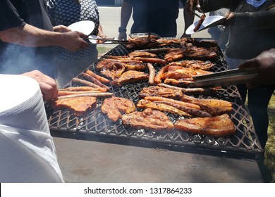 South African People Braaing (cooking) Meat Together. Diversity Concept Image. 