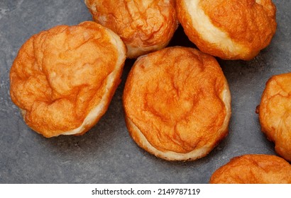 South African vetkoek, deep fried savory dough, on mottled grey background with copy space