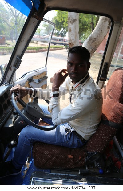 South Asia / India - February 2020: Gulistan\
Tourism Complex,young handsome indian driver driving a minibus for\
tourists