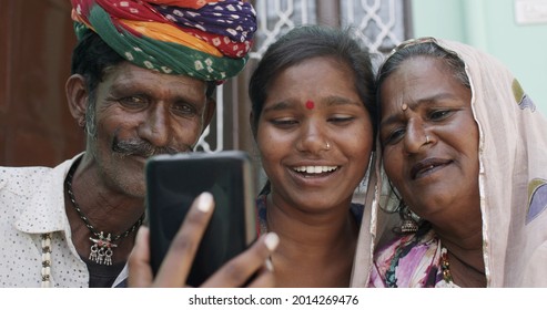 A South Asian Family In Traditional Clothes And Jewelry Making A Video Call Captured In India