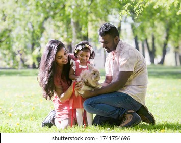 A South Asian Happy Young Family Is Walking In City Park