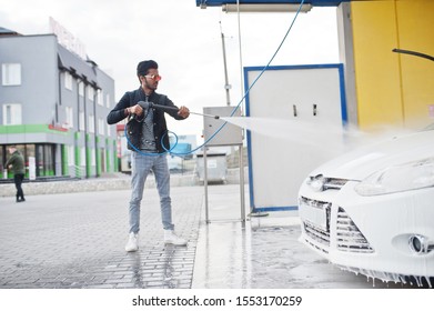 South Asian Man Or Indian Male Washing His White Transportation On Car Wash.