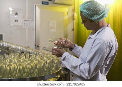 South Asian Senior Male Factory Worker Or Expert Quality Staff Is Checking Bottles Line For Beverage