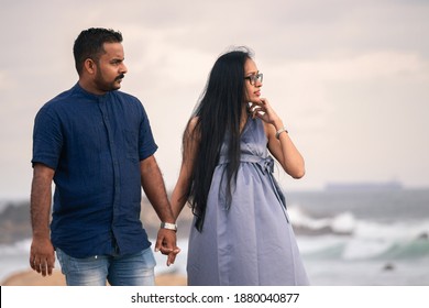 South Asian, Sri Lankan Couple Holding Hands In The Evening, Looking At The Sunset, Maternity Fashion, Expectations Of A Child.