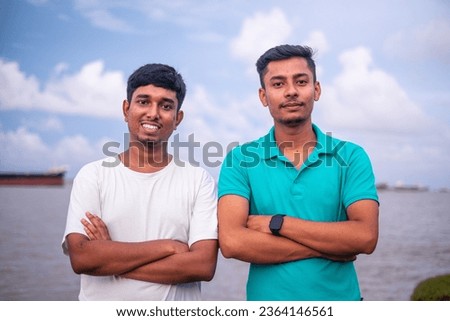 South asian young handsome boys in front of a river, portrait of young friends 