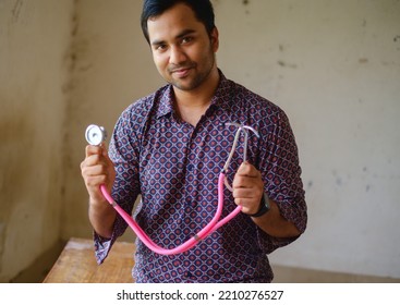 South Asian Young Male Doctor Holding A Stethoscope Wearing Shirt 