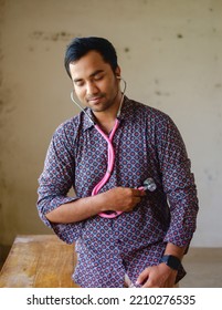 South Asian Young Male Doctor Holding A Stethoscope Wearing Shirt 