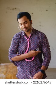 South Asian Young Male Doctor Holding A Stethoscope Wearing Shirt 