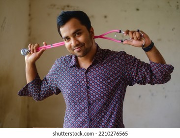 South Asian Young Male Doctor Holding A Stethoscope Wearing Shirt 