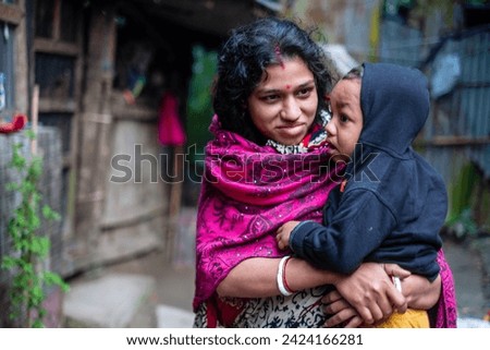 South asian young mother holding her baby boy in her arms 