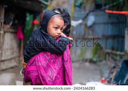 South asian young mother holding her baby boy in her arms 